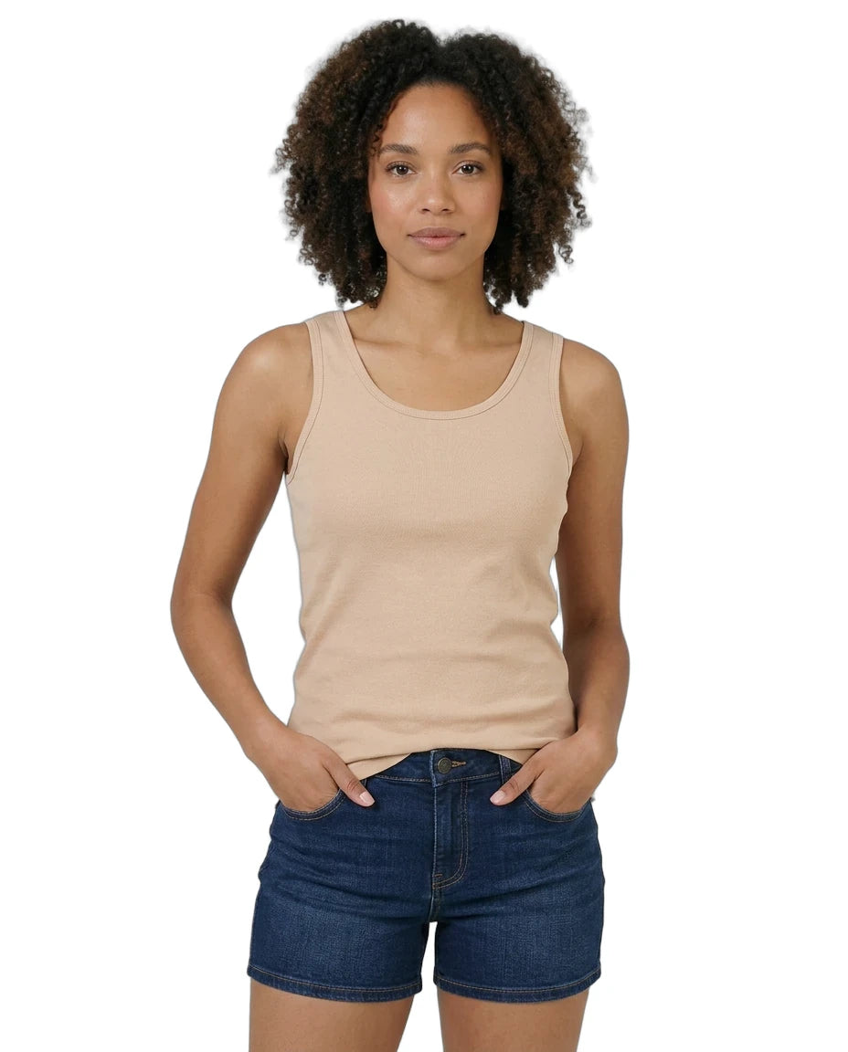 Woman wearing a beige tank top and denim shorts on a white background