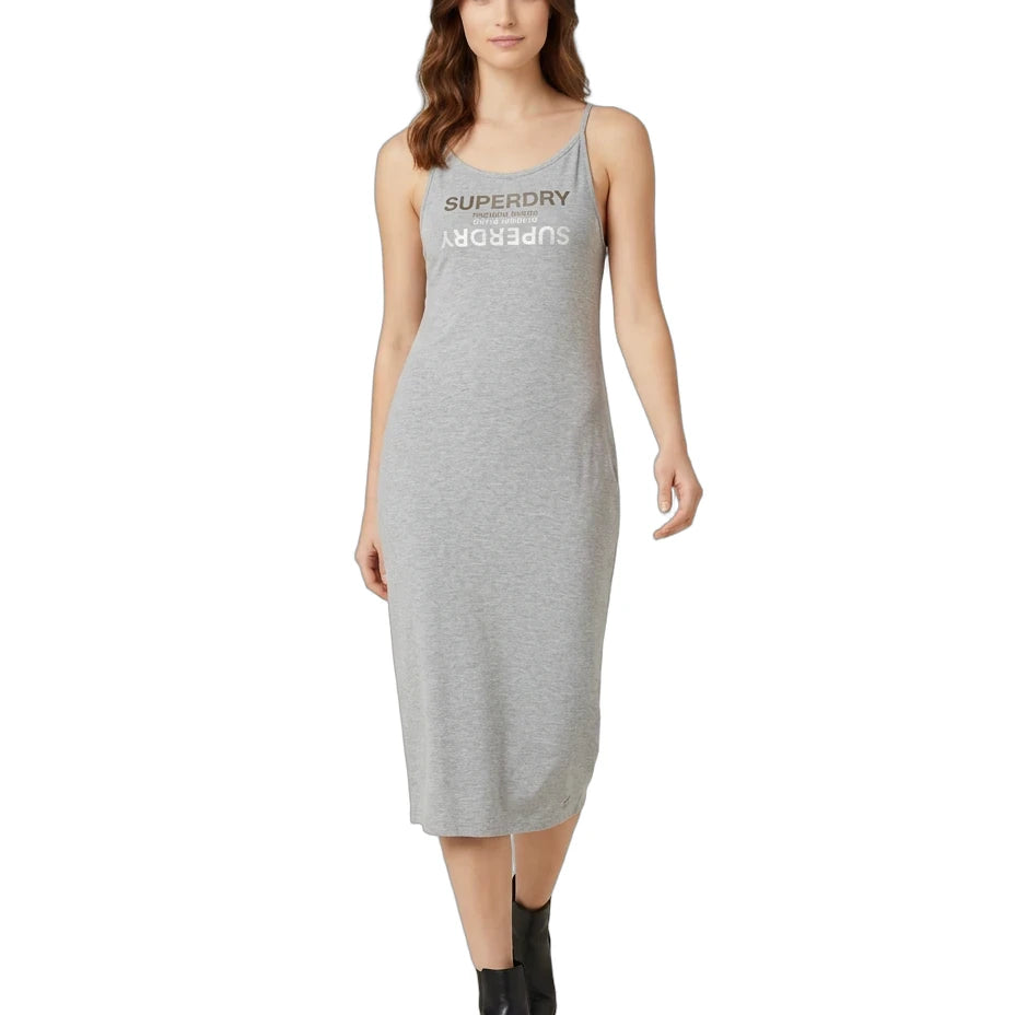 A woman modeling a light gray sleeveless midi dress with 'SUPERDRY AUGUSTS' printed in dark gray across the chest, paired with black ankle boots, on a solid white background.
