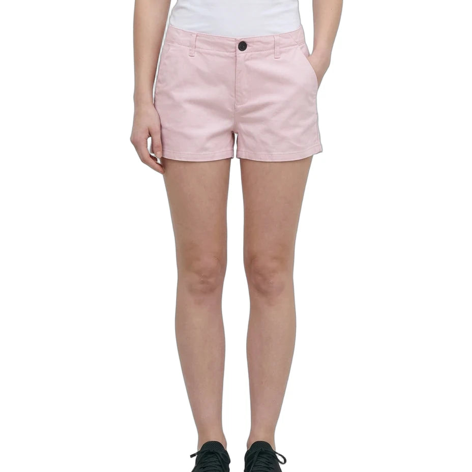 A model wearing light pink chino shorts, a white tank top, and black sneakers, shown from the waist down against a plain white background.