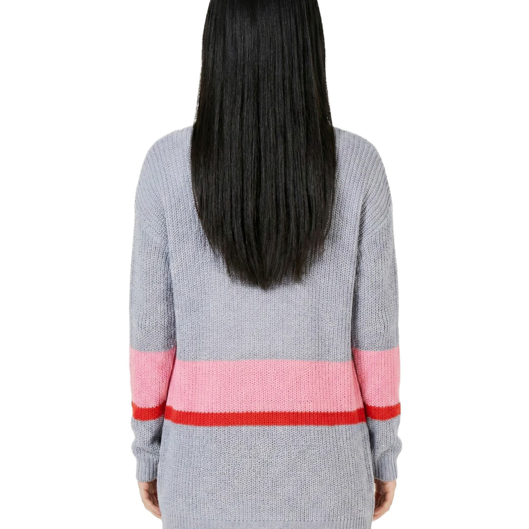 Person wearing a gray sweater with pink and red stripes on a white background