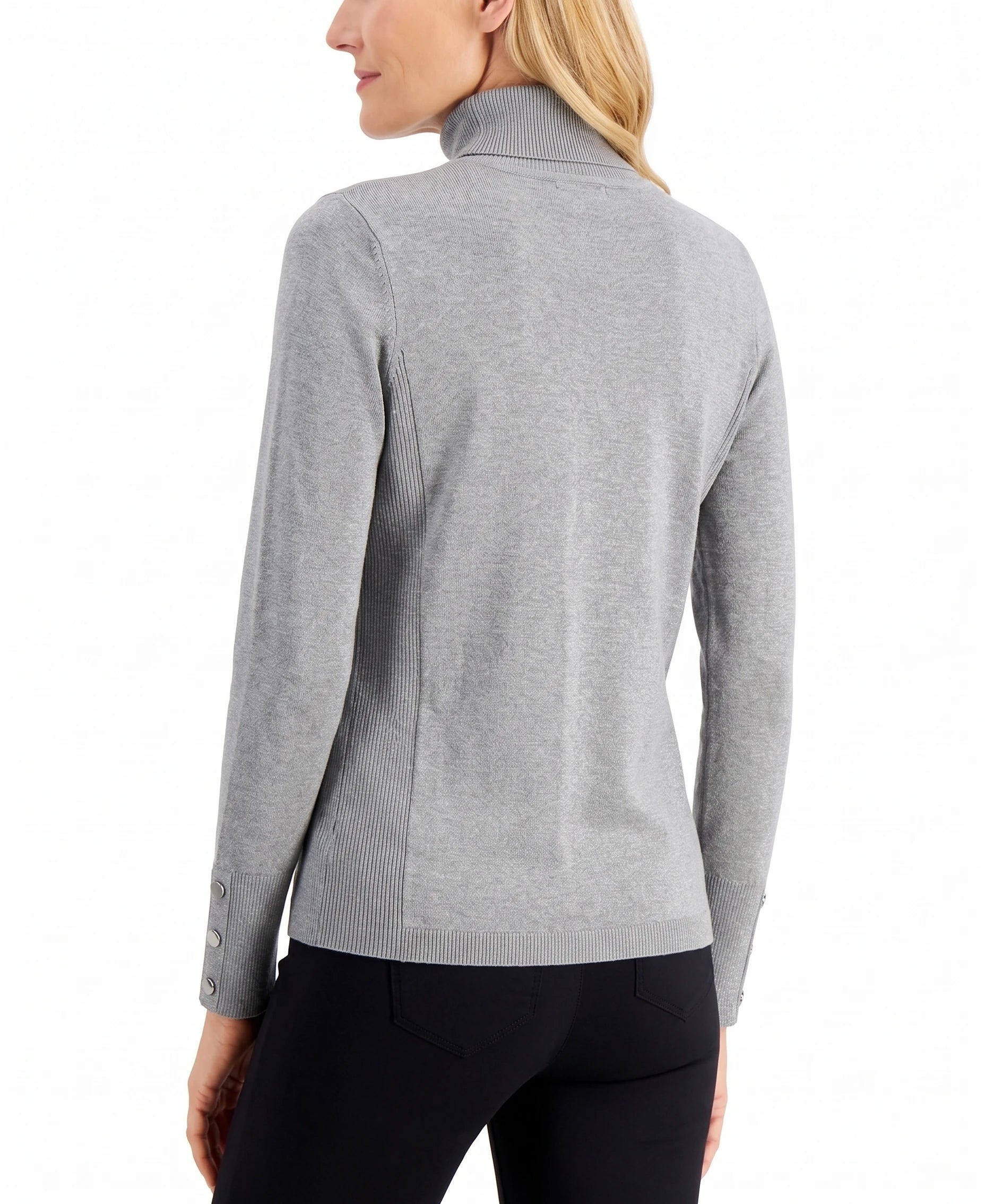 A woman shown from the back wearing a light gray ribbed mock neck sweater with button details on the cuffs, paired with black pants, against a plain white background.