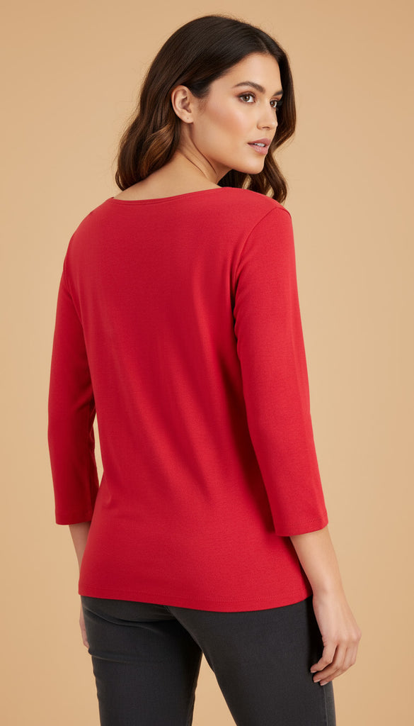 Woman wearing a red top with a beige background