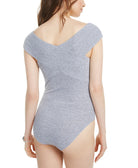 Woman wearing a gray one-piece swimsuit on a white background