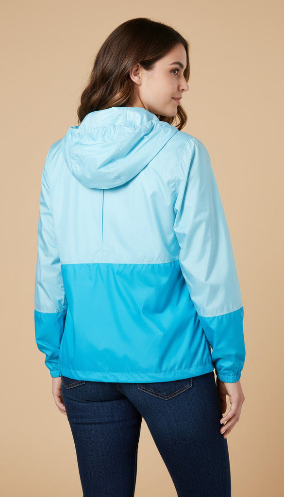 Woman wearing a two-tone blue jacket on a beige background