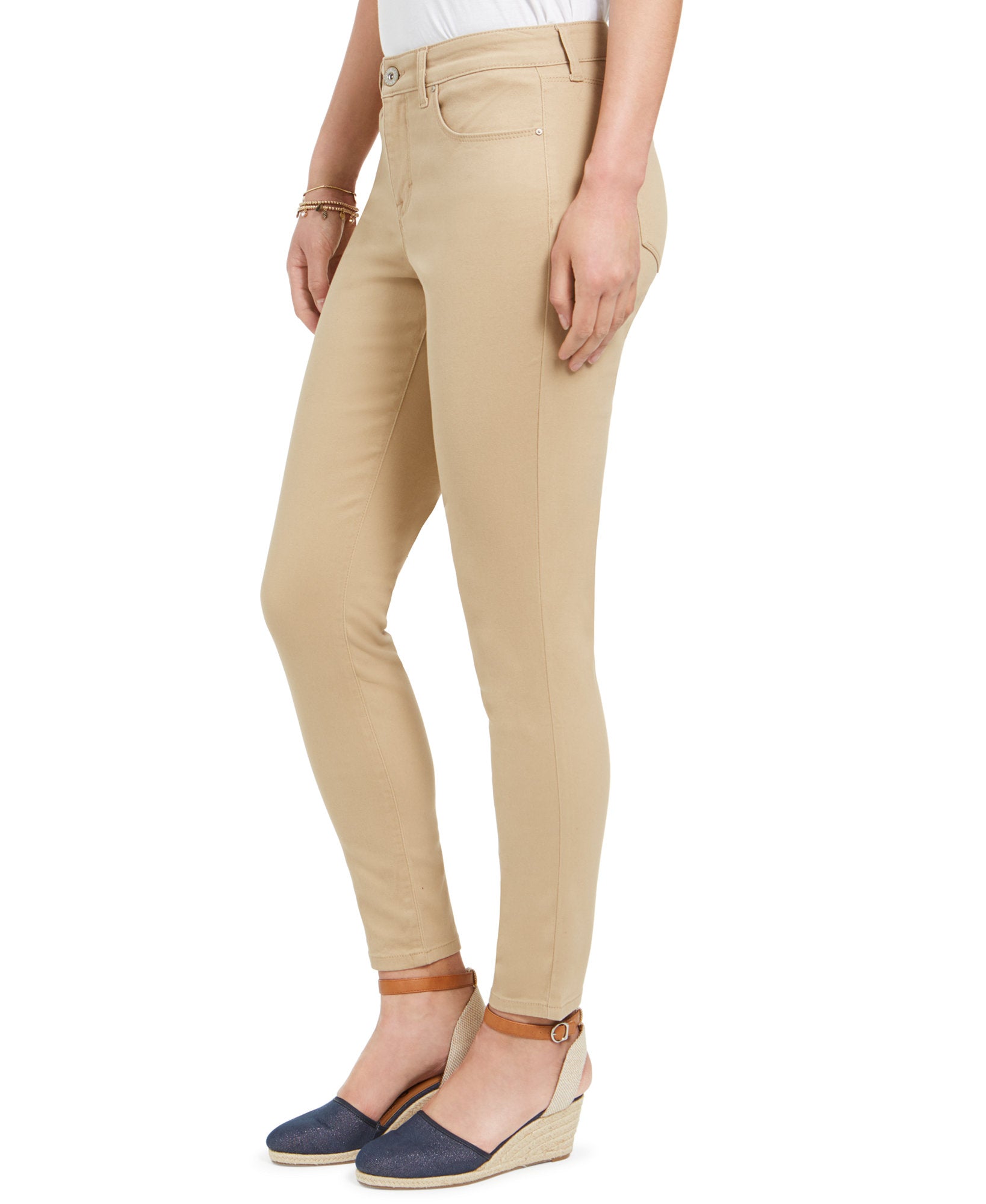 Beige pants worn by a person on a white background