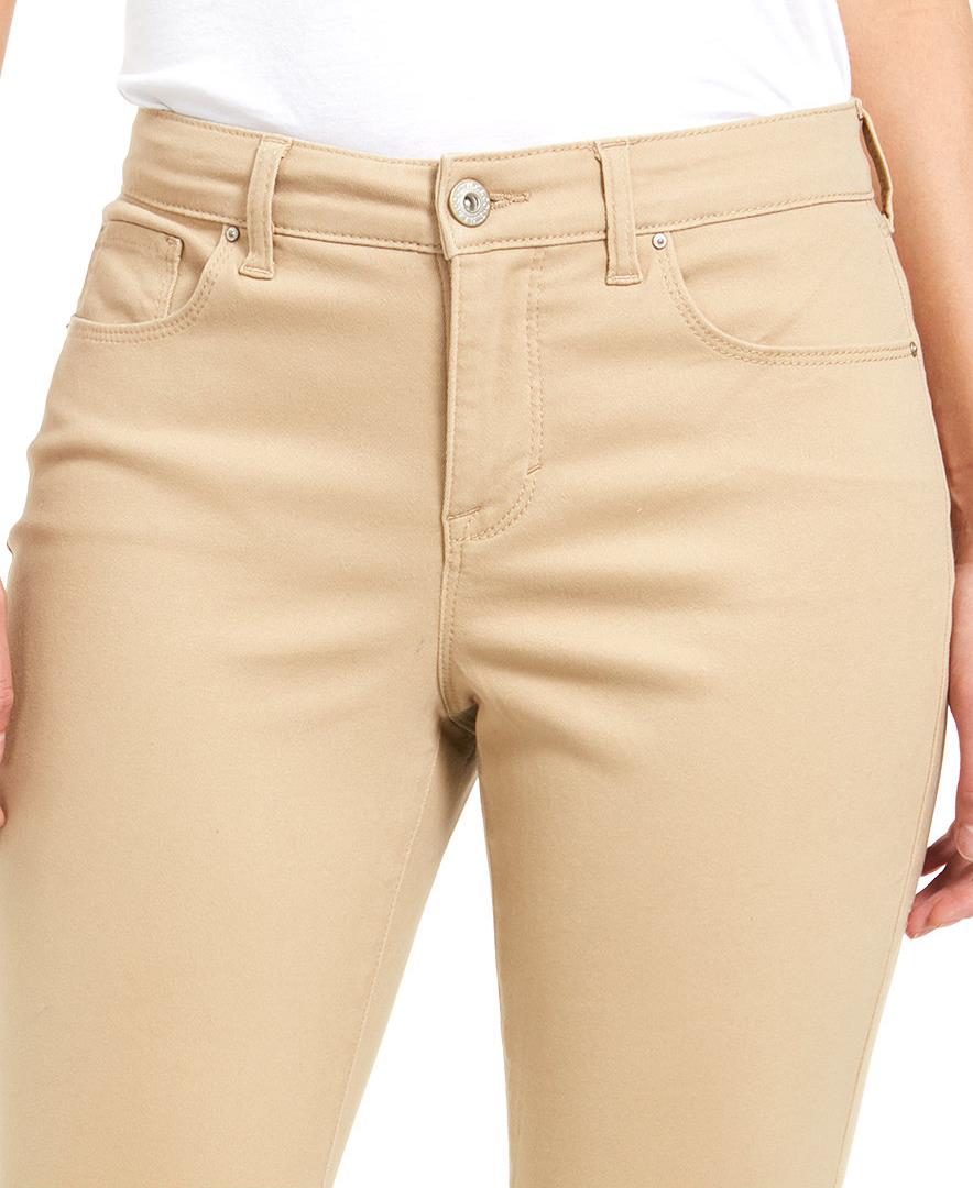 Beige pants worn by a person on a white background