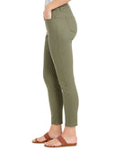 Green pants worn by a person on a white background