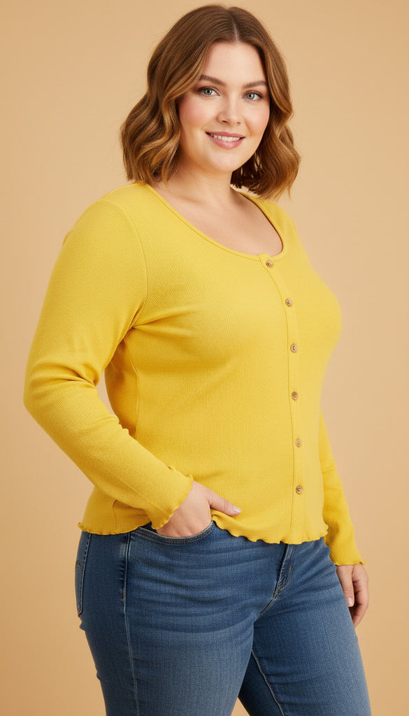 Woman wearing a yellow long-sleeve top and blue jeans on a beige background