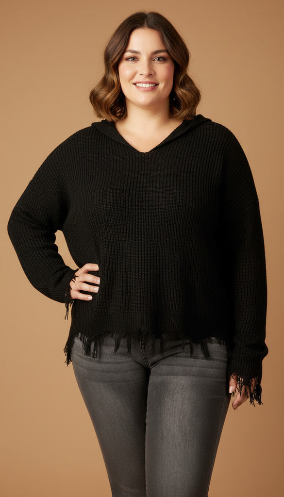 Woman wearing a black hoodie with fringe details on a brown background