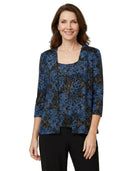 Woman wearing a blue floral patterned top on a white background