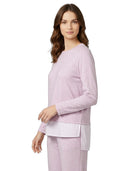 Woman wearing a light purple pajama set on a white background