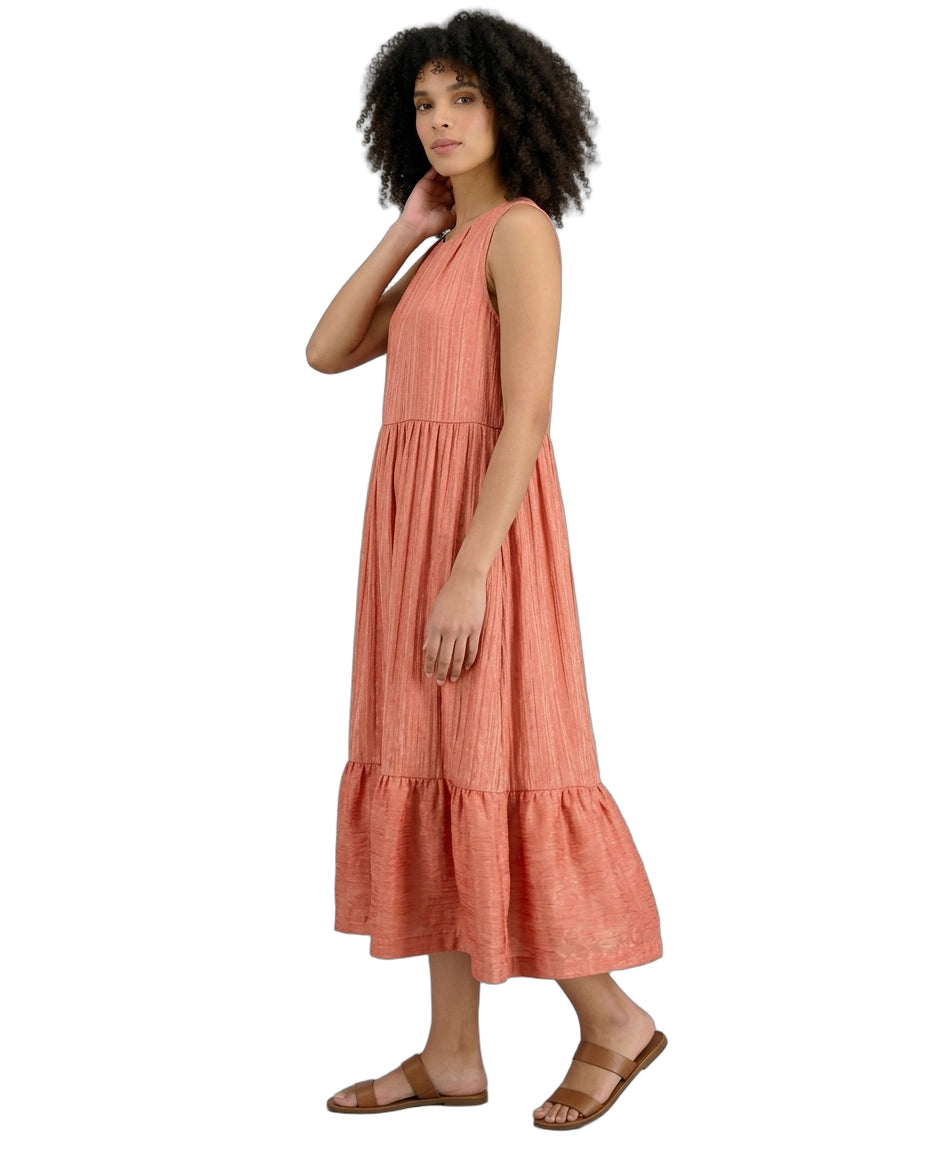 Woman wearing a coral dress on a white background