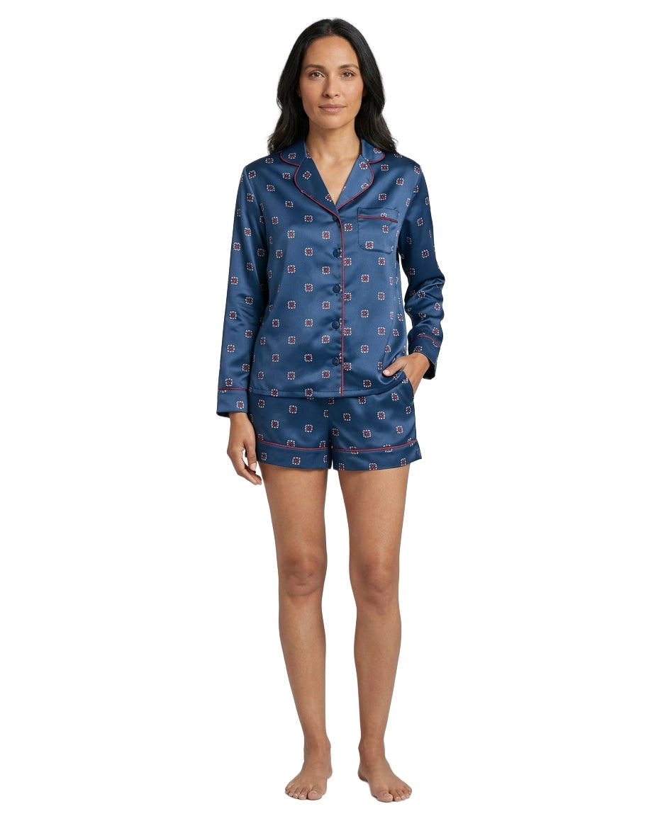 Woman wearing a blue patterned pajama set on a white background