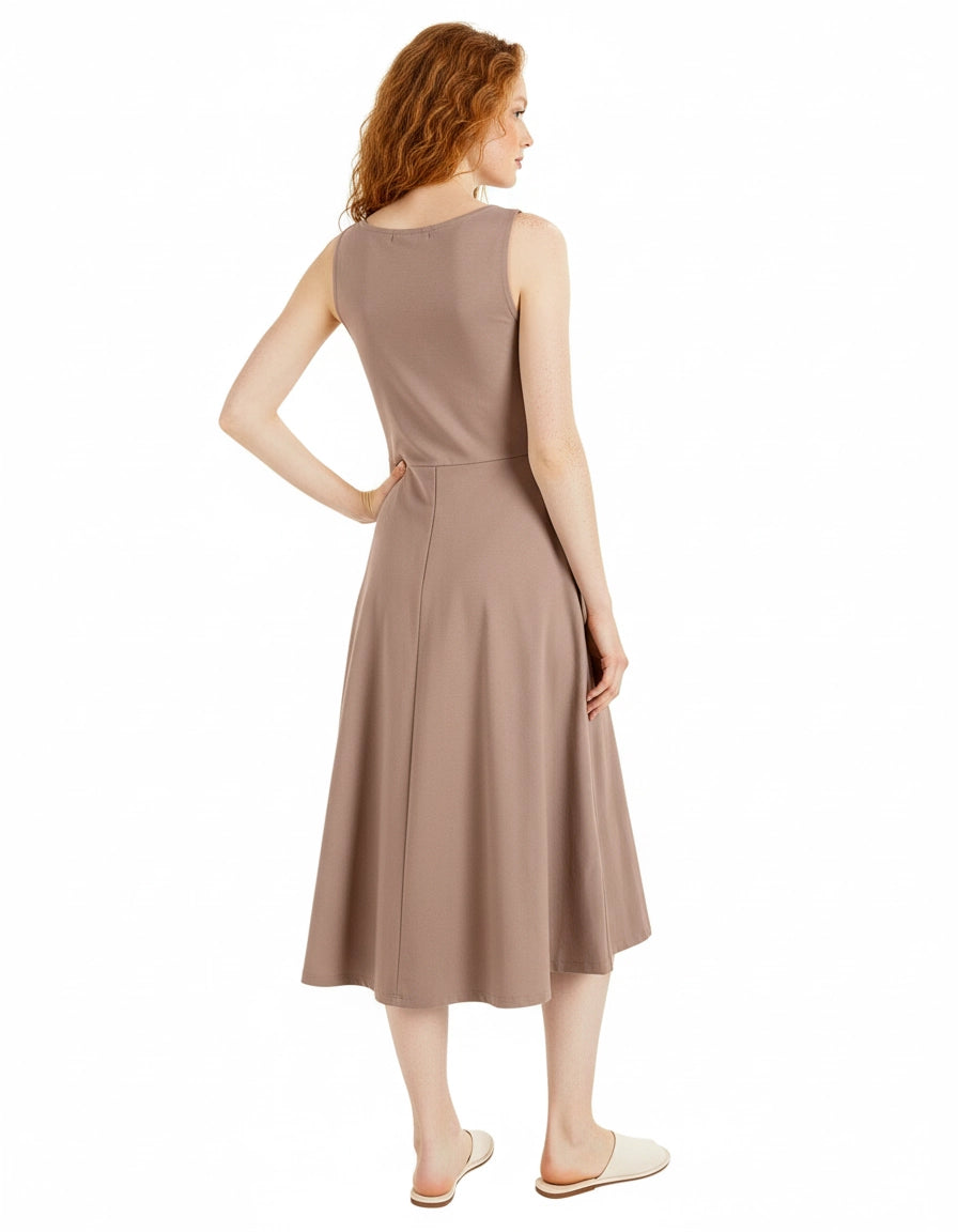 Woman wearing a beige sleeveless dress on a white background