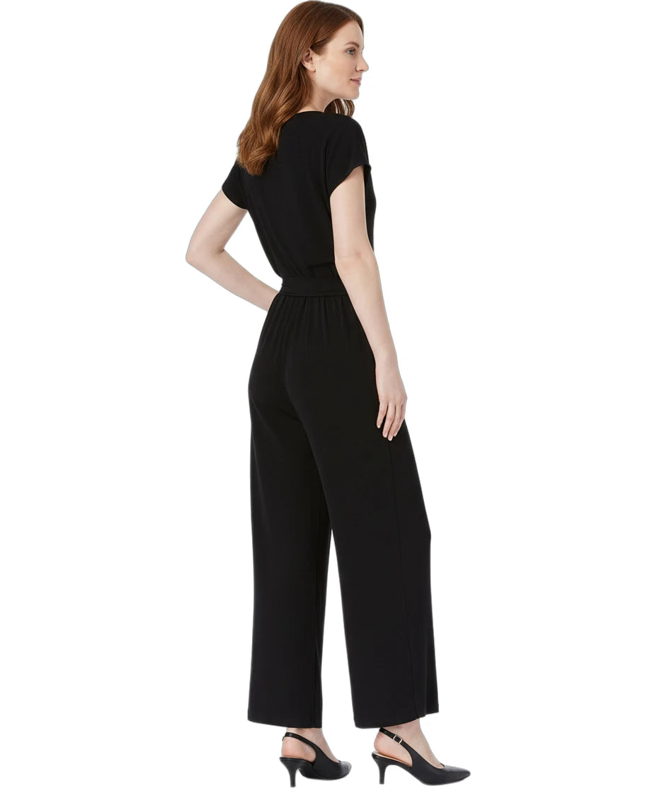 Woman wearing a black jumpsuit on a white background