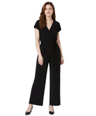 Woman wearing a black jumpsuit on a white background