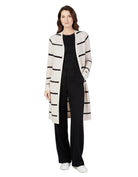Woman wearing a long, striped cardigan over a black outfit on a white background