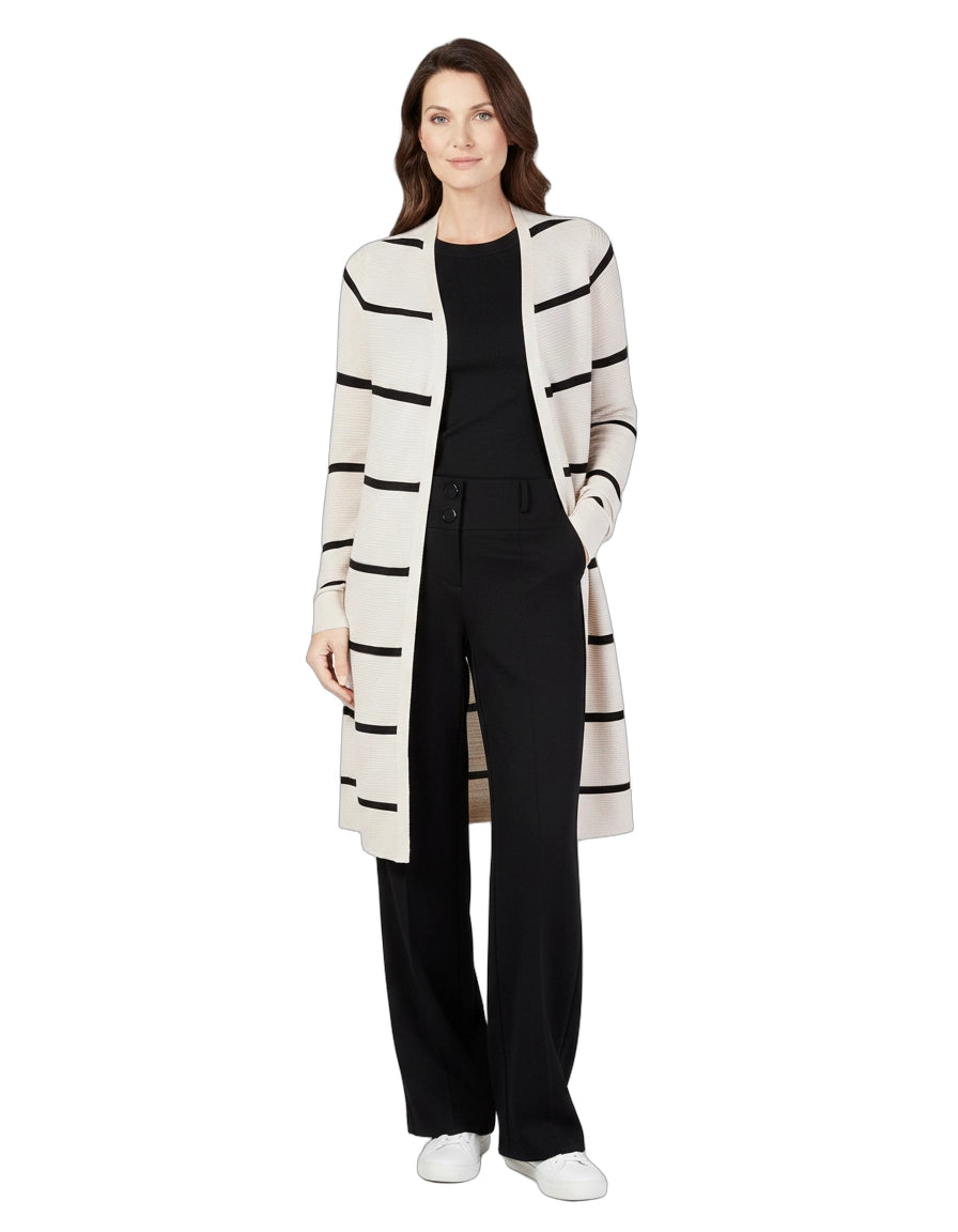 Woman wearing a long, striped cardigan over a black outfit on a white background