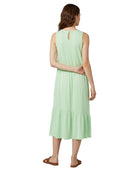 Woman wearing a light green dress on a white background