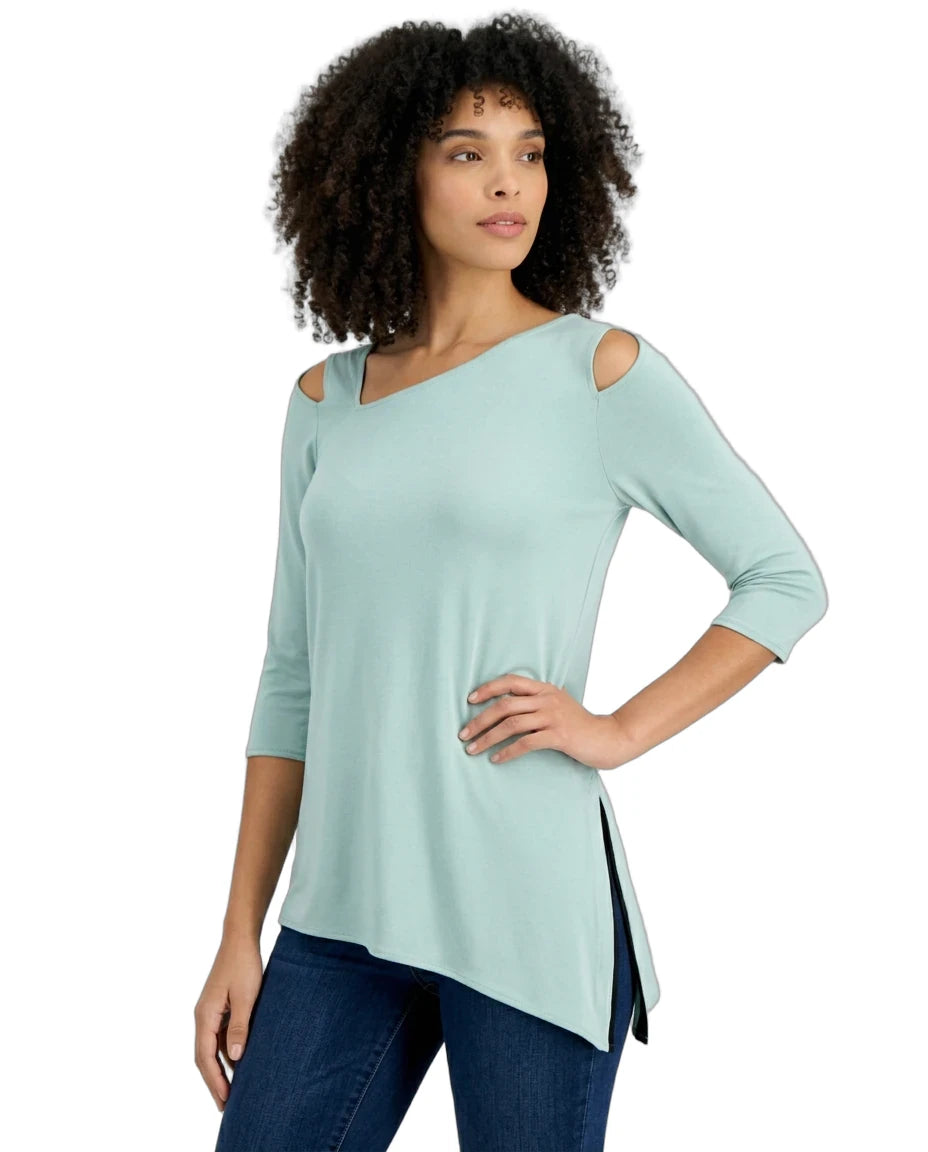 Woman wearing a light blue top with cut-out shoulders on a white background