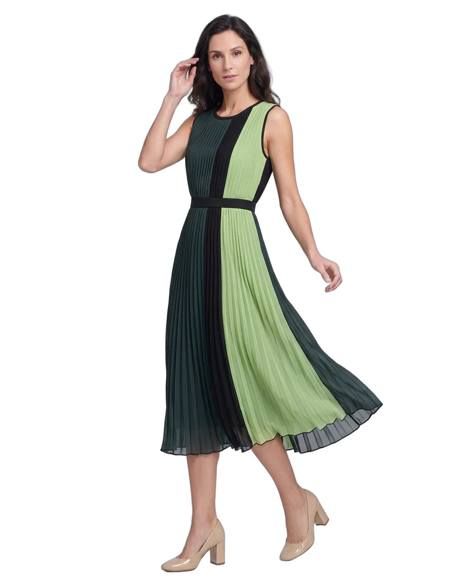 A woman modeling a sleeveless pleated midi dress with a color-blocked design in dark green and light green, featuring a black waistband and black side panels, paired with beige high heels against a white background.