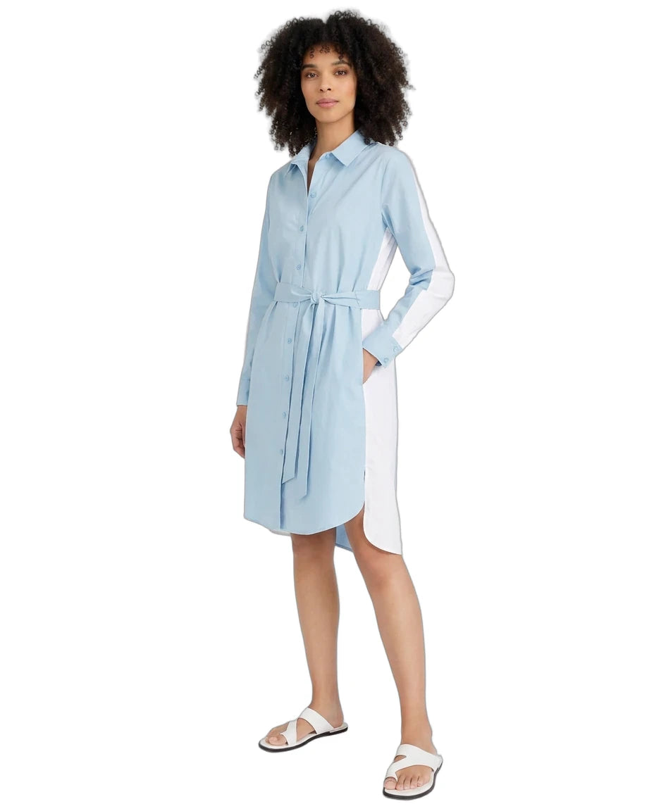 A woman modeling a light blue and white color-block shirt dress with a tie waist belt, shown against a plain white background.