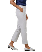 A person wearing light gray cropped trousers with side pockets, paired with a navy top and metallic silver loafers, shown against a plain white background.