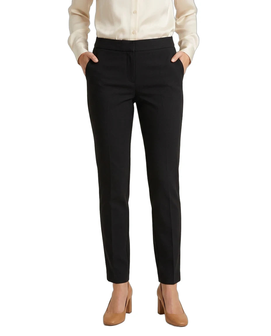 A model wearing black slim-fit ankle-length trousers, paired with a cream button-up blouse and tan heeled pumps, shown against a plain white background.