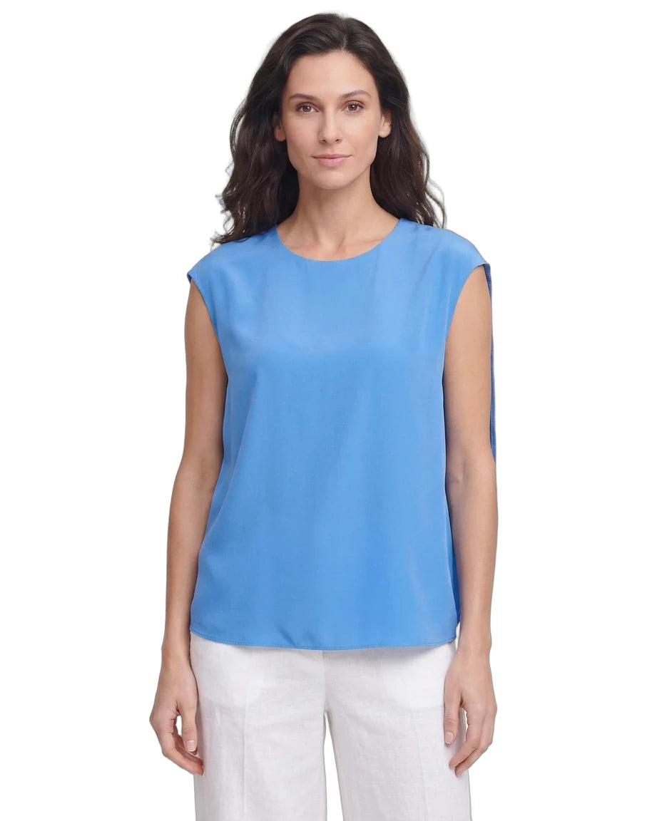 Woman wearing a blue sleeveless top on a white background