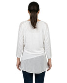 Woman wearing a white layered top on a white background