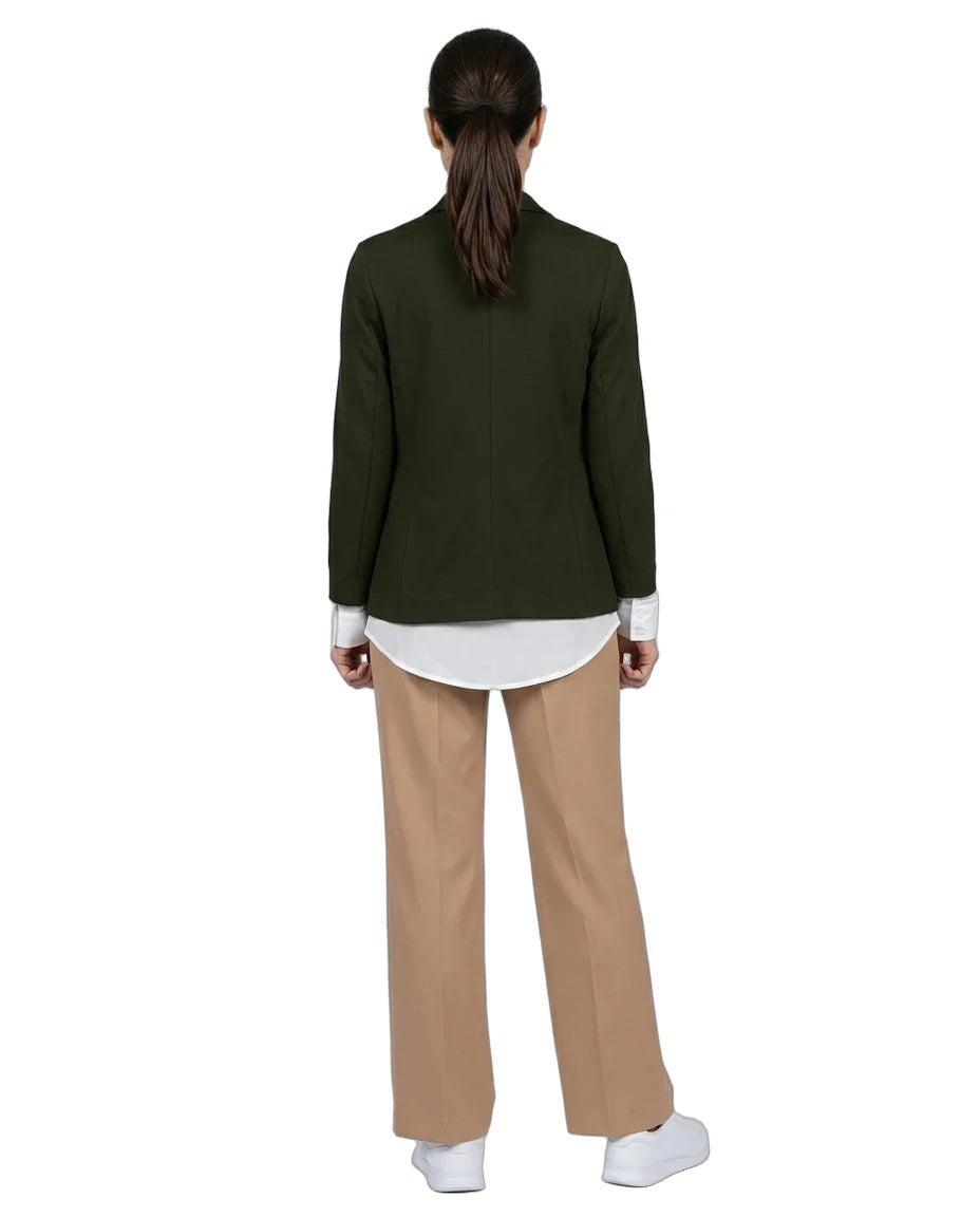 A model shown from the back wearing an olive green blazer over a white shirt, paired with beige wide-leg trousers and white sneakers, against a plain white background.