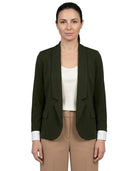 A woman modeling a dark olive green tailored blazer with shawl lapels, worn open over a cream top and tan trousers, against a plain white background.