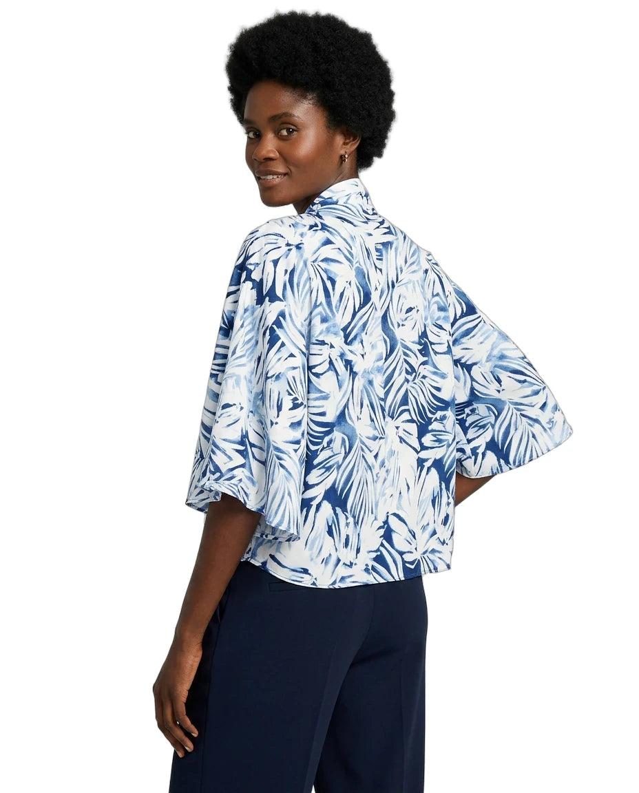 Woman wearing a blue and white floral kimono-style shirt on a white background