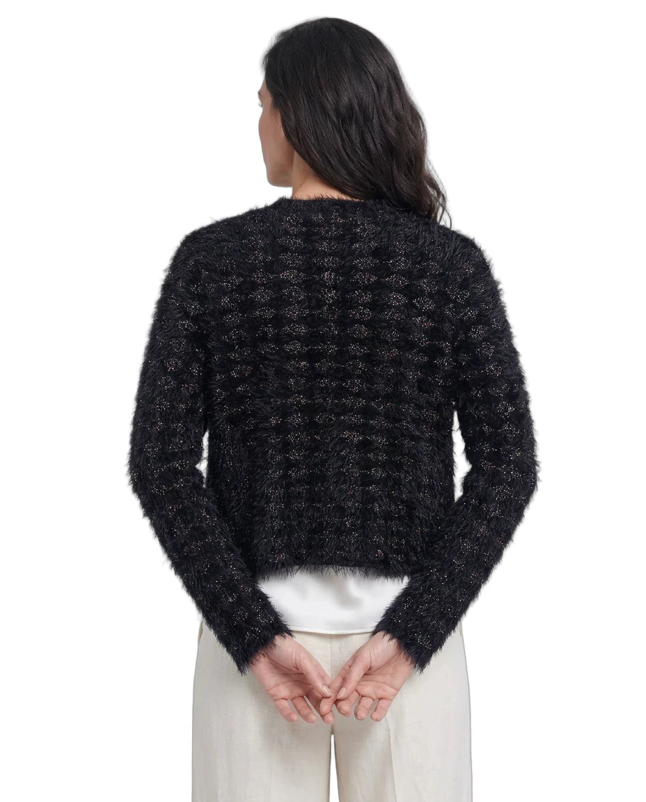 Person wearing a black textured sweater on a white background