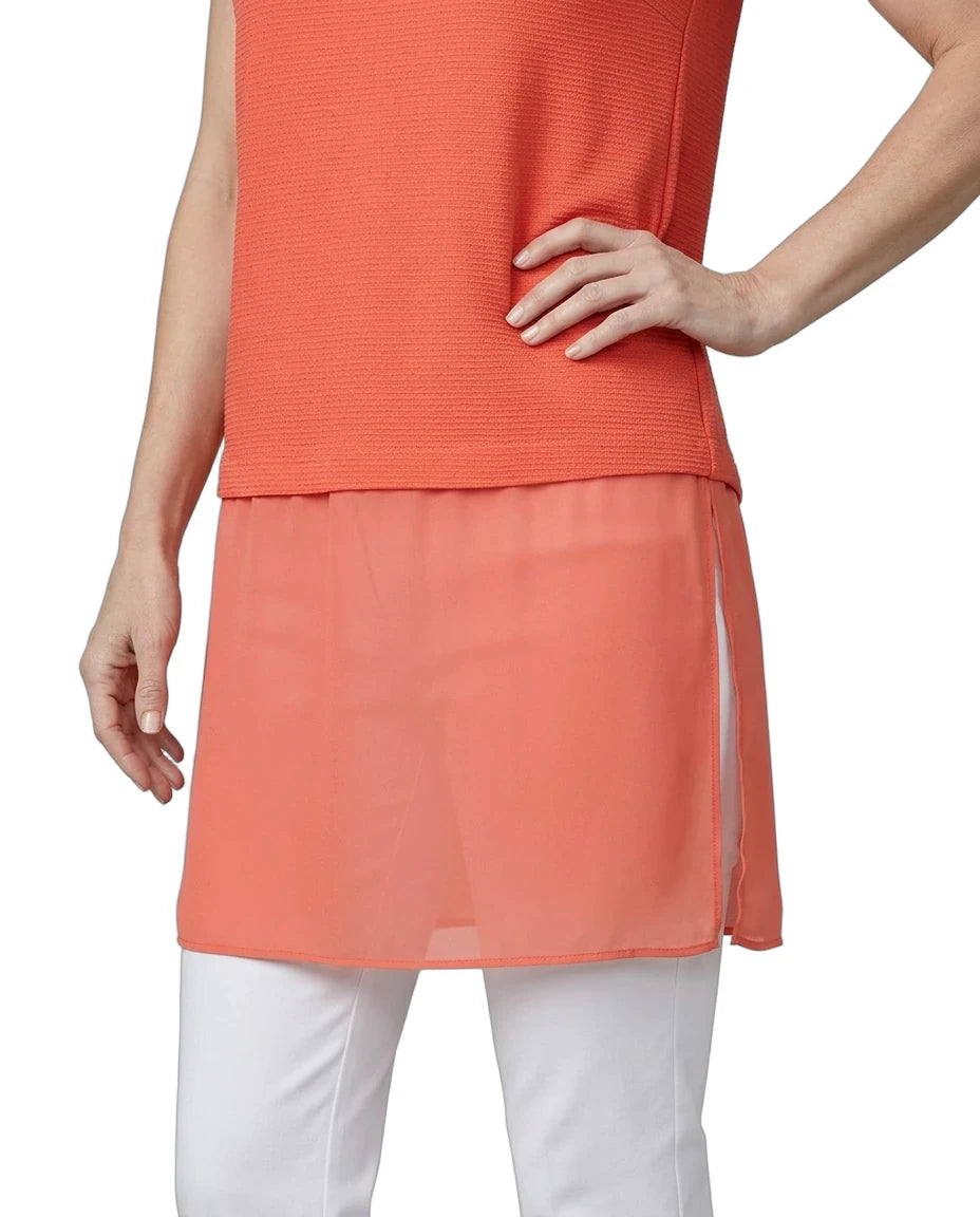 Coral sleeveless top and skirt with white pants on a plain background