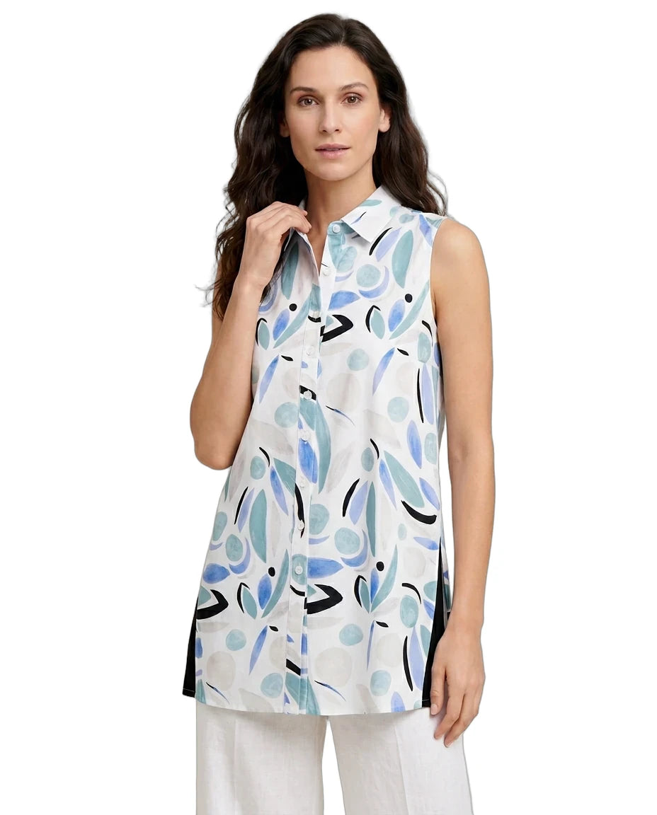 Woman wearing a sleeveless, patterned blouse with a white background