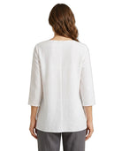 Woman wearing a white blouse with a three-quarter sleeve on a white background