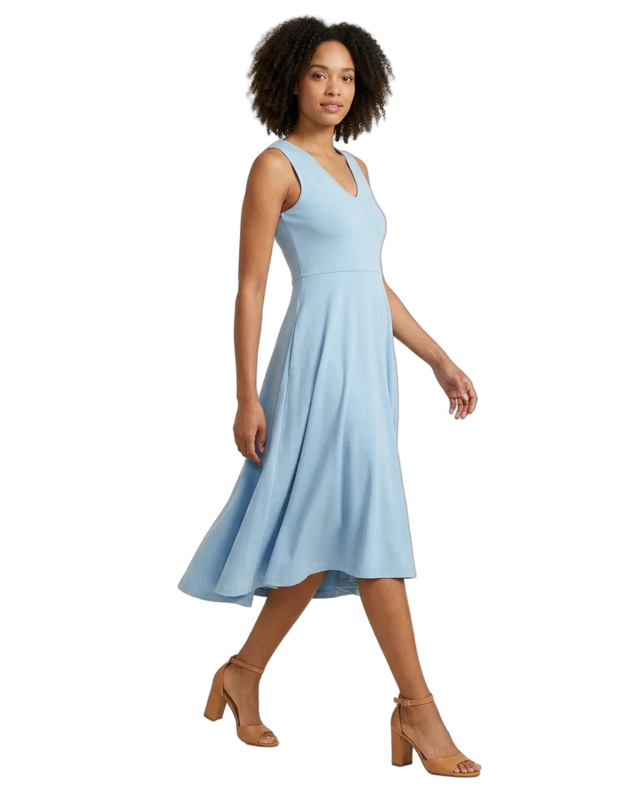 A woman modeling a sleeveless light blue V-neck midi dress with a flared skirt, paired with tan heeled sandals, against a plain white background.
