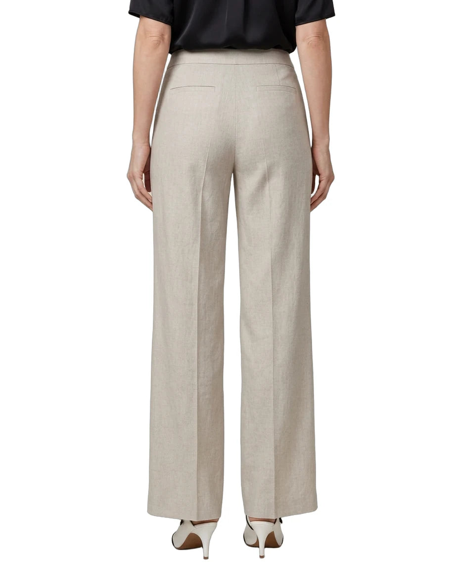 A model shown from the back wearing high-waisted, wide-leg trousers in a light beige linen-like fabric, paired with a black top and white heels, on a solid white background.