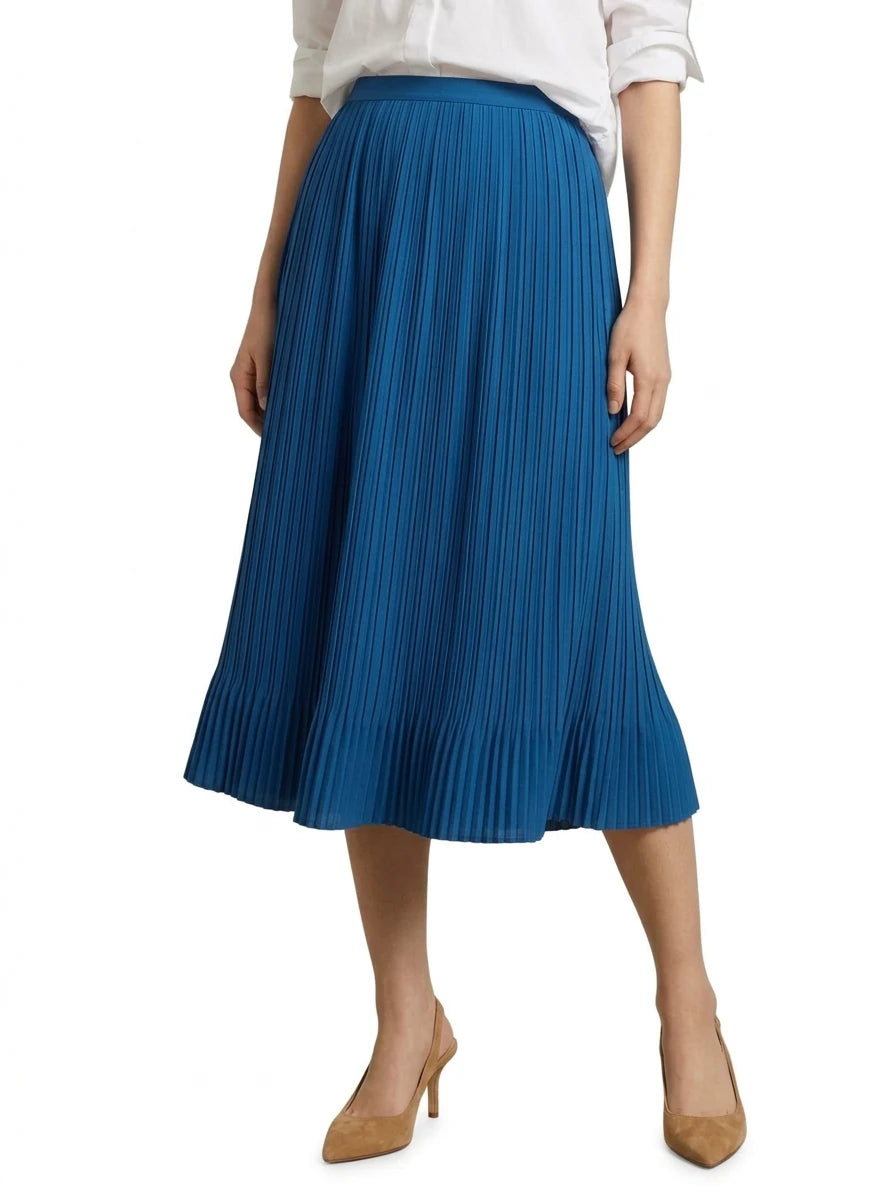 A model wearing a vibrant blue pleated midi skirt with a matching tie waist, styled with a white blouse and tan heels against a plain white background.
