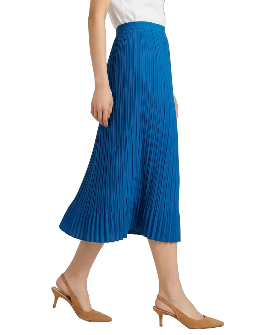 A model wearing a bright blue pleated midi skirt with a white top and tan slingback heels, shown from the waist down against a plain white background.