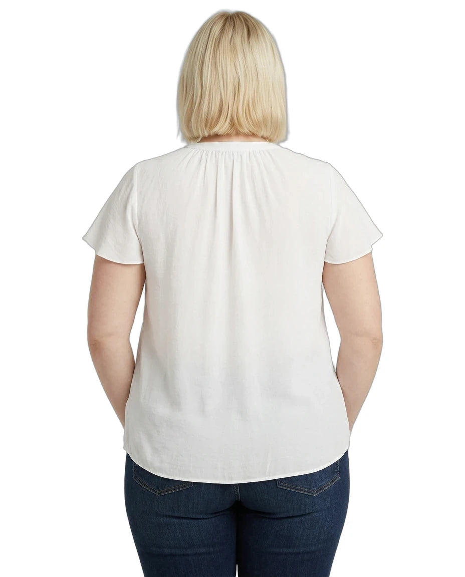 Person wearing a white blouse and blue jeans on a white background