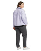 A woman shown from the back wearing a light lavender button-up shirt, dark gray trousers, and white sneakers against a plain white background.