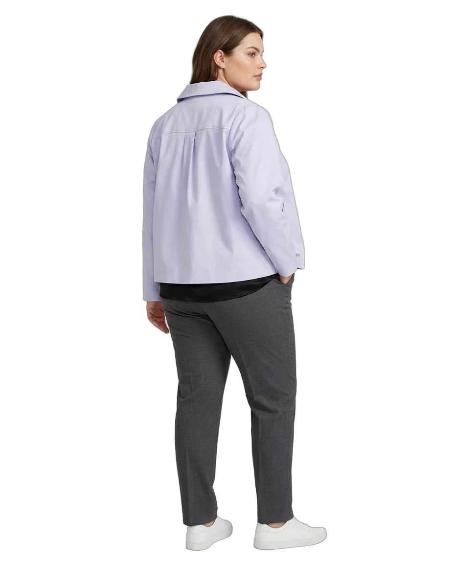 A woman shown from the back wearing a light lavender button-up shirt, dark gray trousers, and white sneakers against a plain white background.