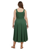A woman viewed from the back wearing a sleeveless green midi dress with a square neckline and a flared skirt, paired with tan sandals, against a plain white background.
