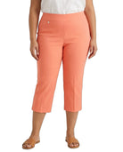 A model wearing a pair of coral orange cropped pants, styled with a white top and tan slide sandals, shown against a plain white background.