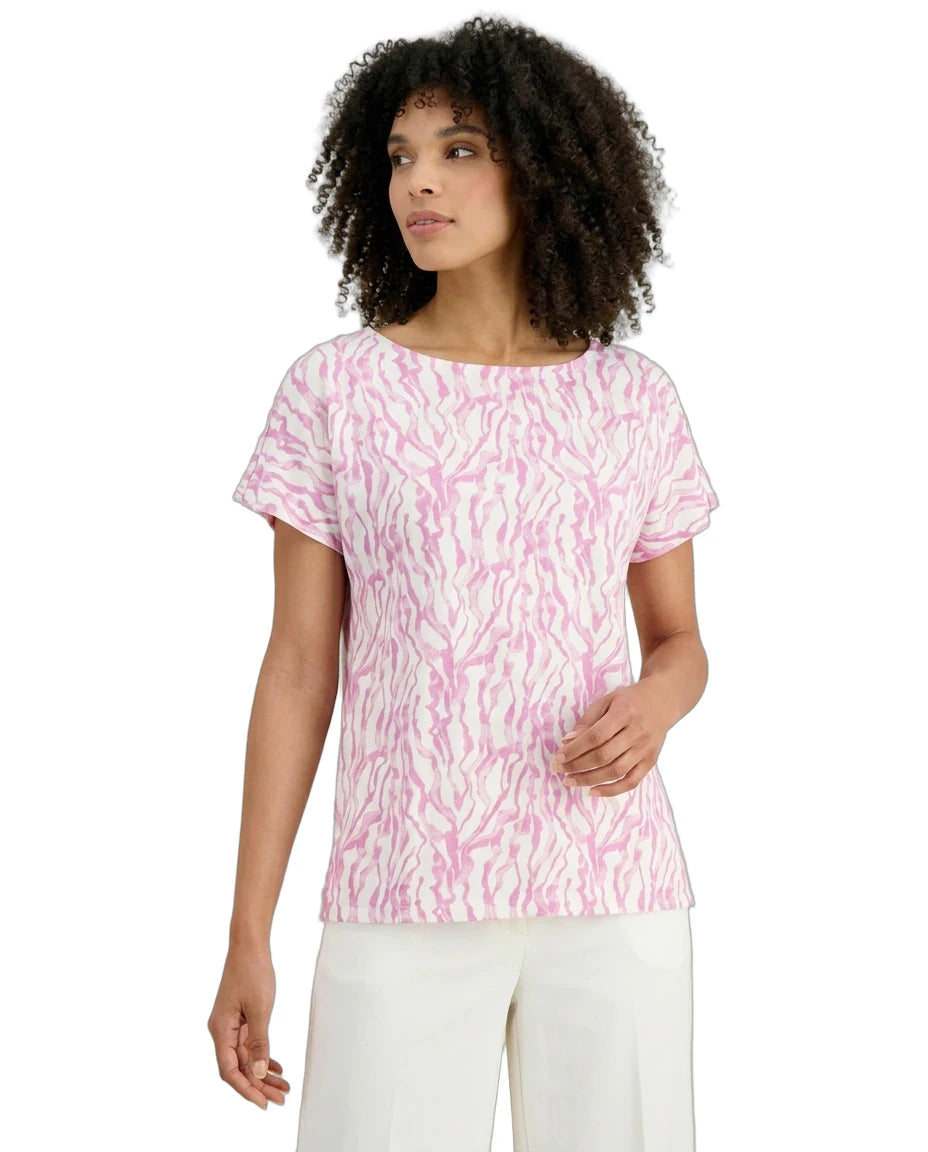 Woman wearing a pink patterned shirt on a white background