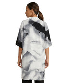 Woman wearing a black and white abstract patterned dress on a white background
