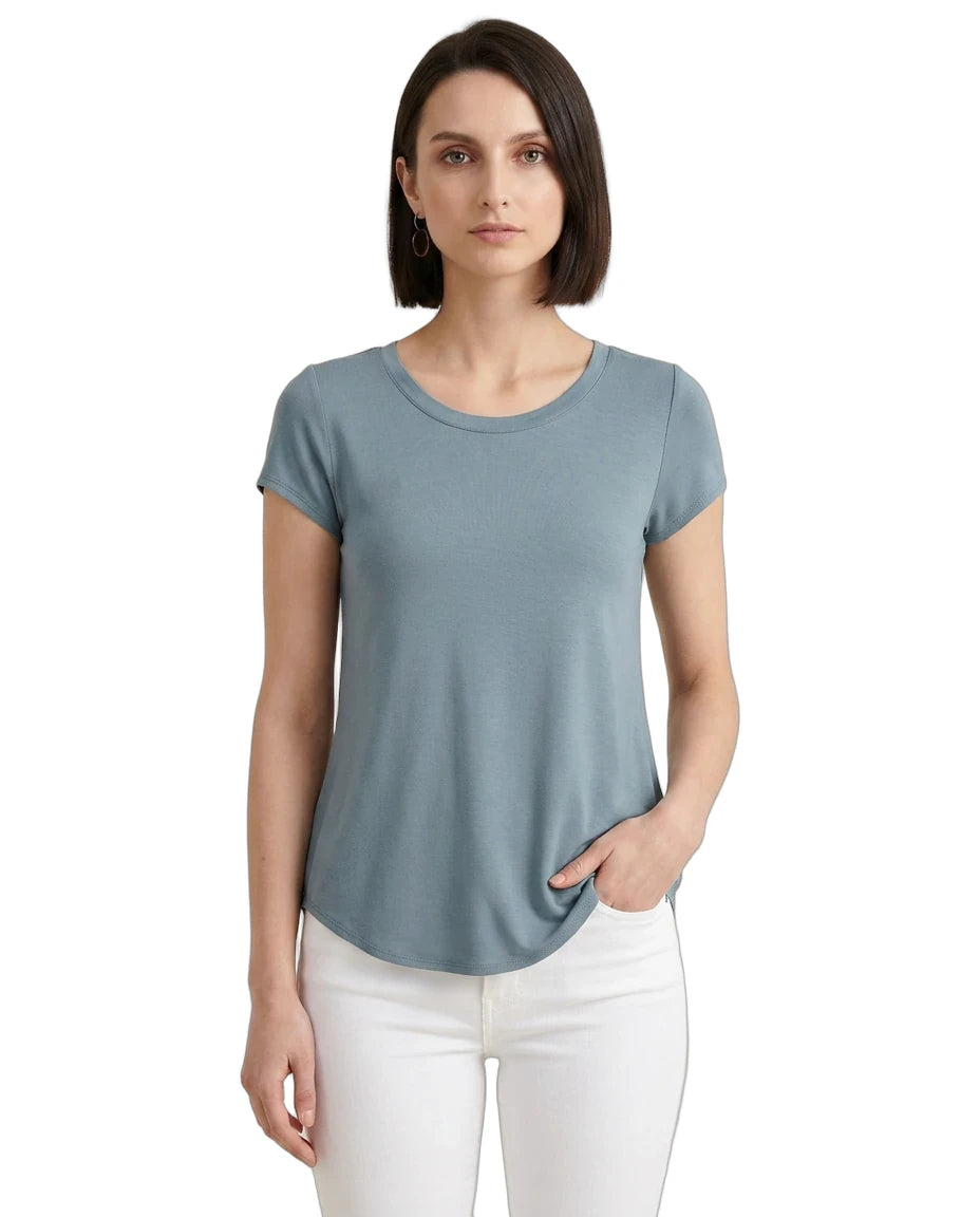 Woman wearing a light blue t-shirt and white pants on a white background