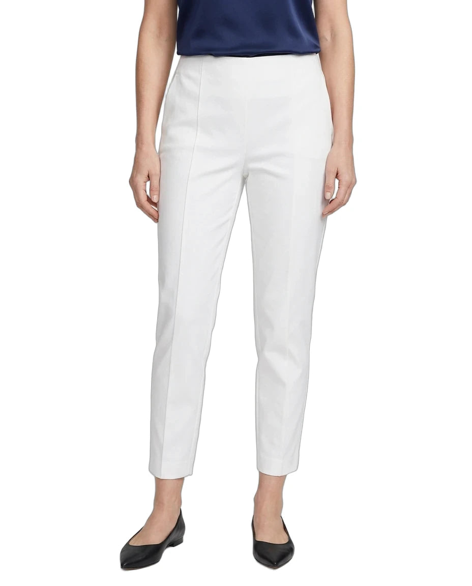 A model wearing white cropped trousers with a straight-leg fit, paired with a navy top and black flats, shown against a plain white background.